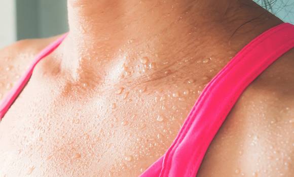 Focus on woman's body with sweat on tanning skin, Healthy lifest
